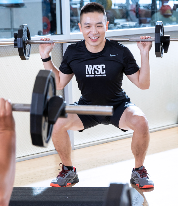 man lifting weights in group fitness - Club Details NYSC